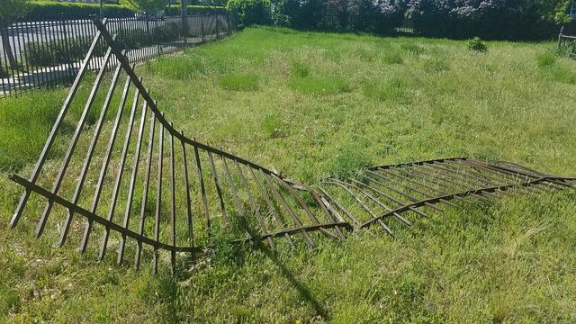 In May, this is what our fence looked like when some kid drove out of the Carroll PE Center parking lot.